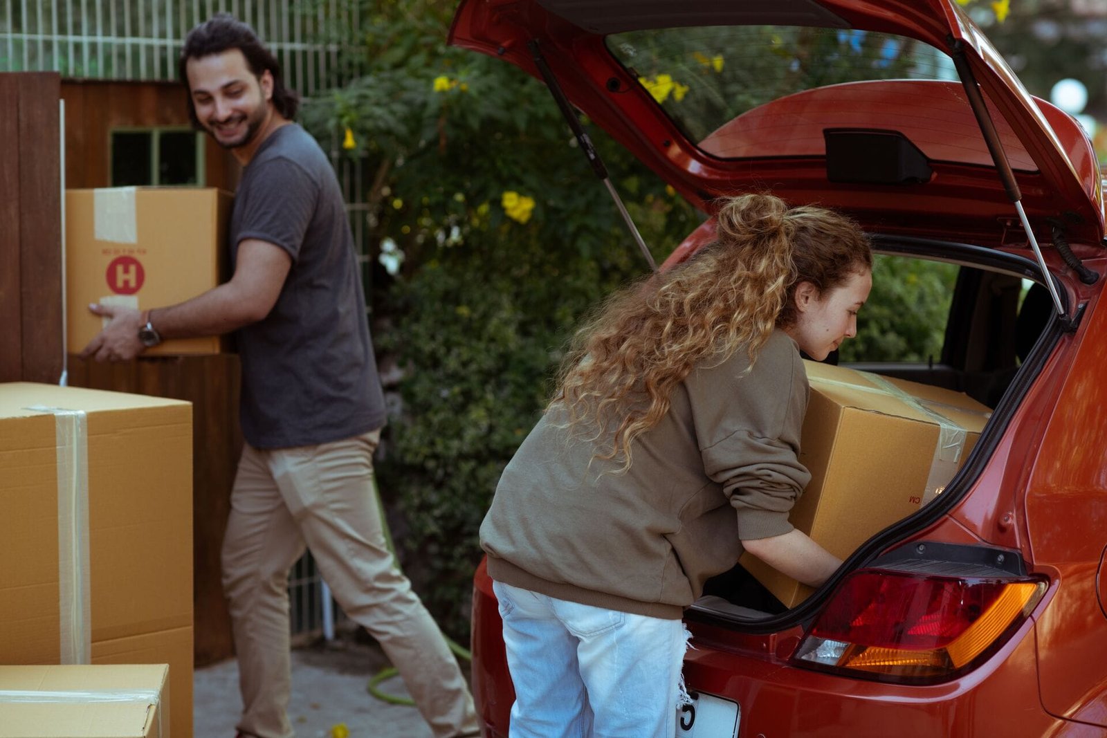Movers loading packed boxes into a car for a home move in Dubai